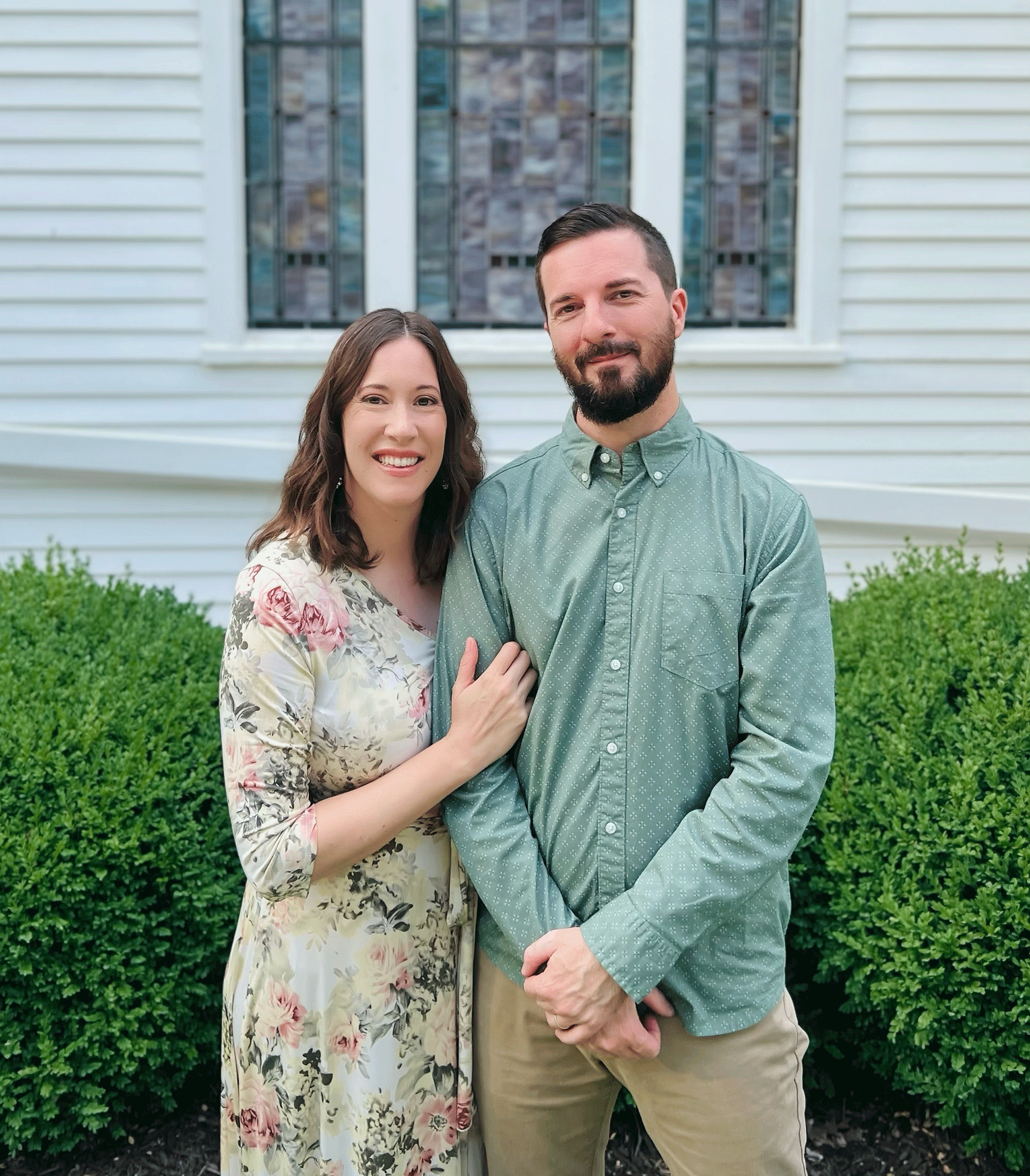 Jay and Rachael Kent standing together in front of a white church